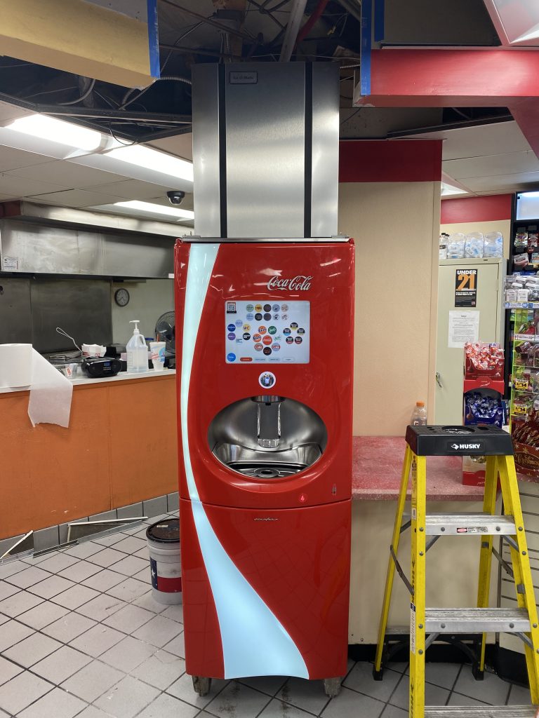 Coca Cola soda machine undergoing maintenance
